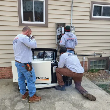 Three men working on a generator outside of a house.
